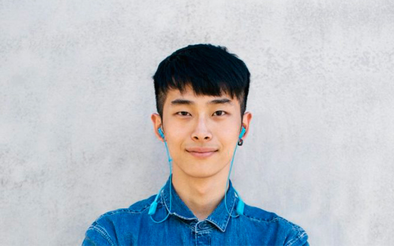 Mladík s modrými sluchátky JBL TUNE 215BT